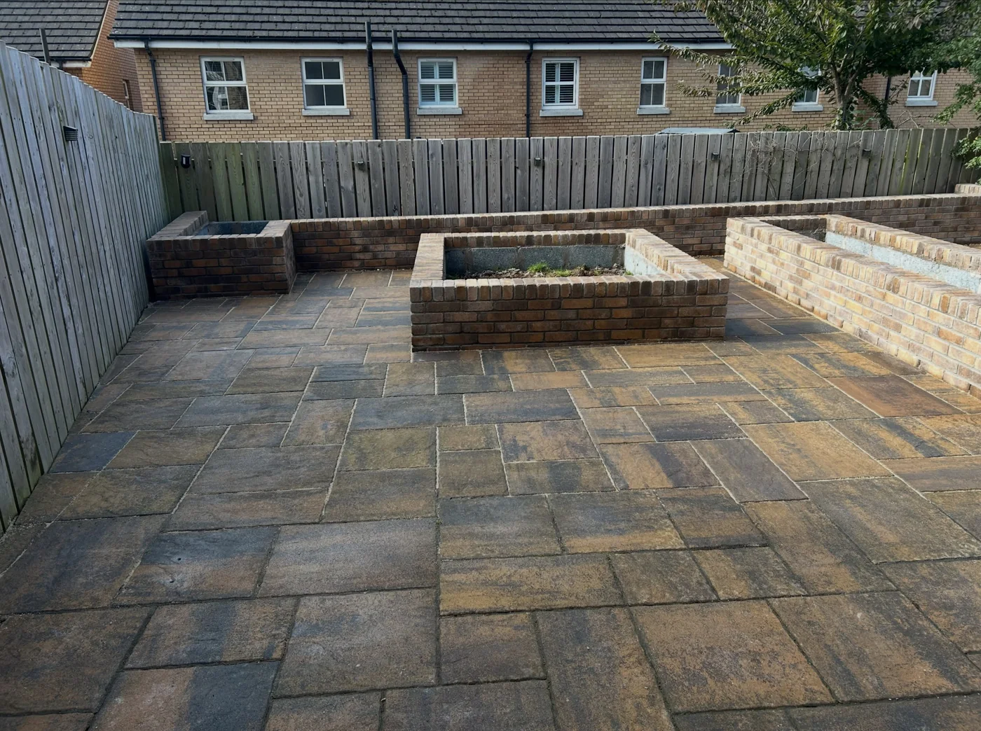 Tobermore historic flags surrounding raised brick flowerbeds
