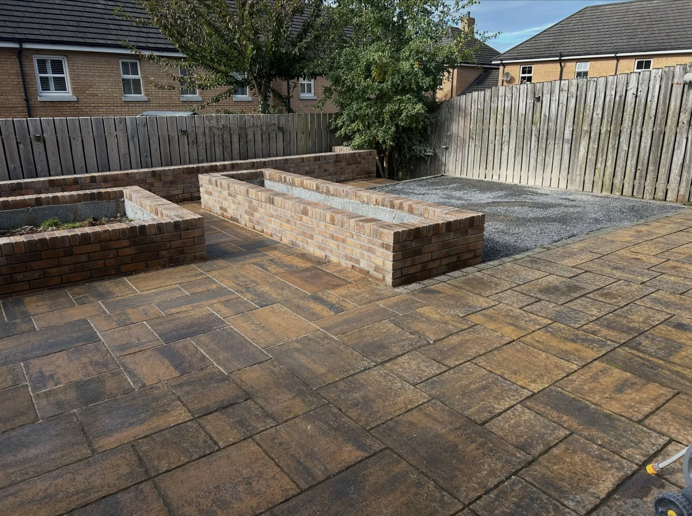 New raised brick flowerbeds with neatly finished corners and coping