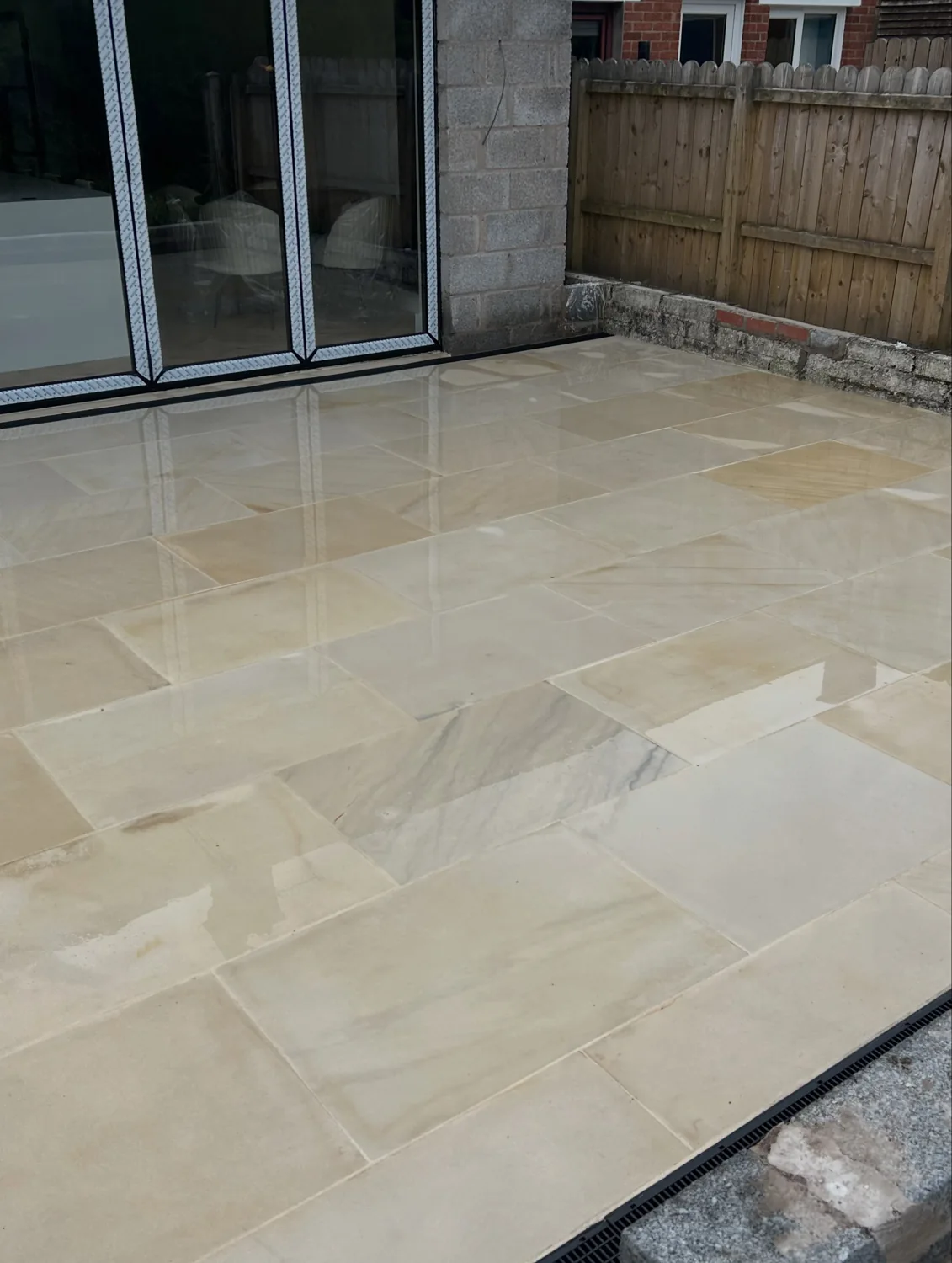 Mourne sandstone patio with lime-coloured joints beside garden doors